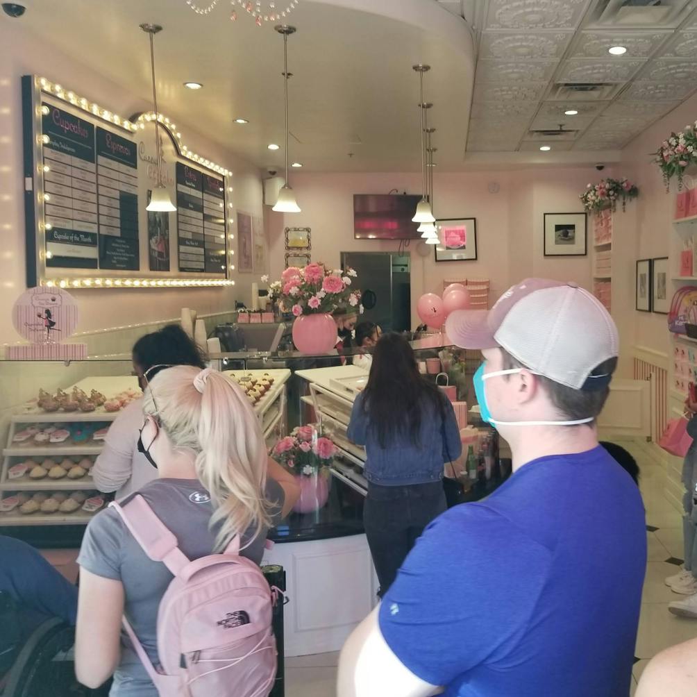 People standing in line inside Casey's Cupcakes in Riverside California 