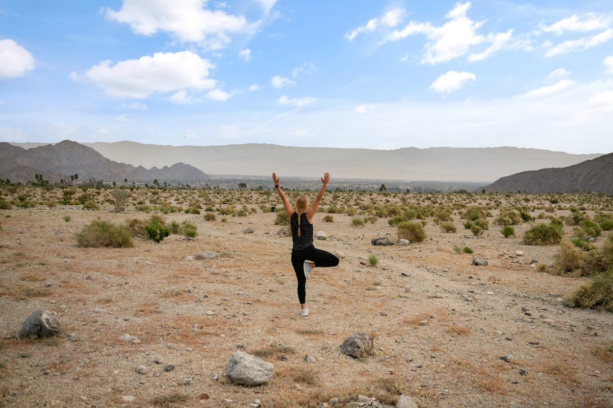 woman yoga pose in desert La Quinta