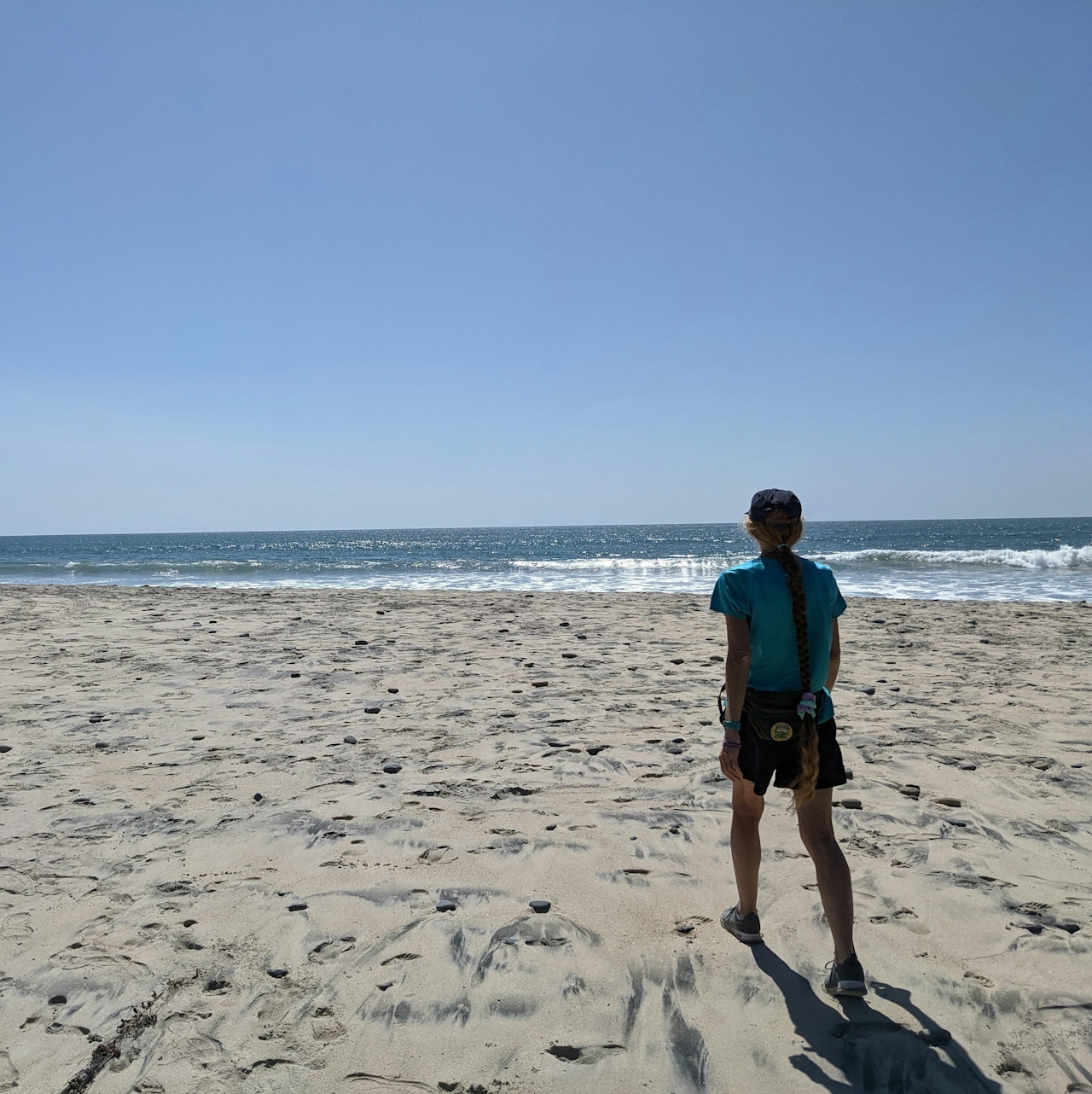 Woman walking on a wide open beach at Carlsbad City Beach 