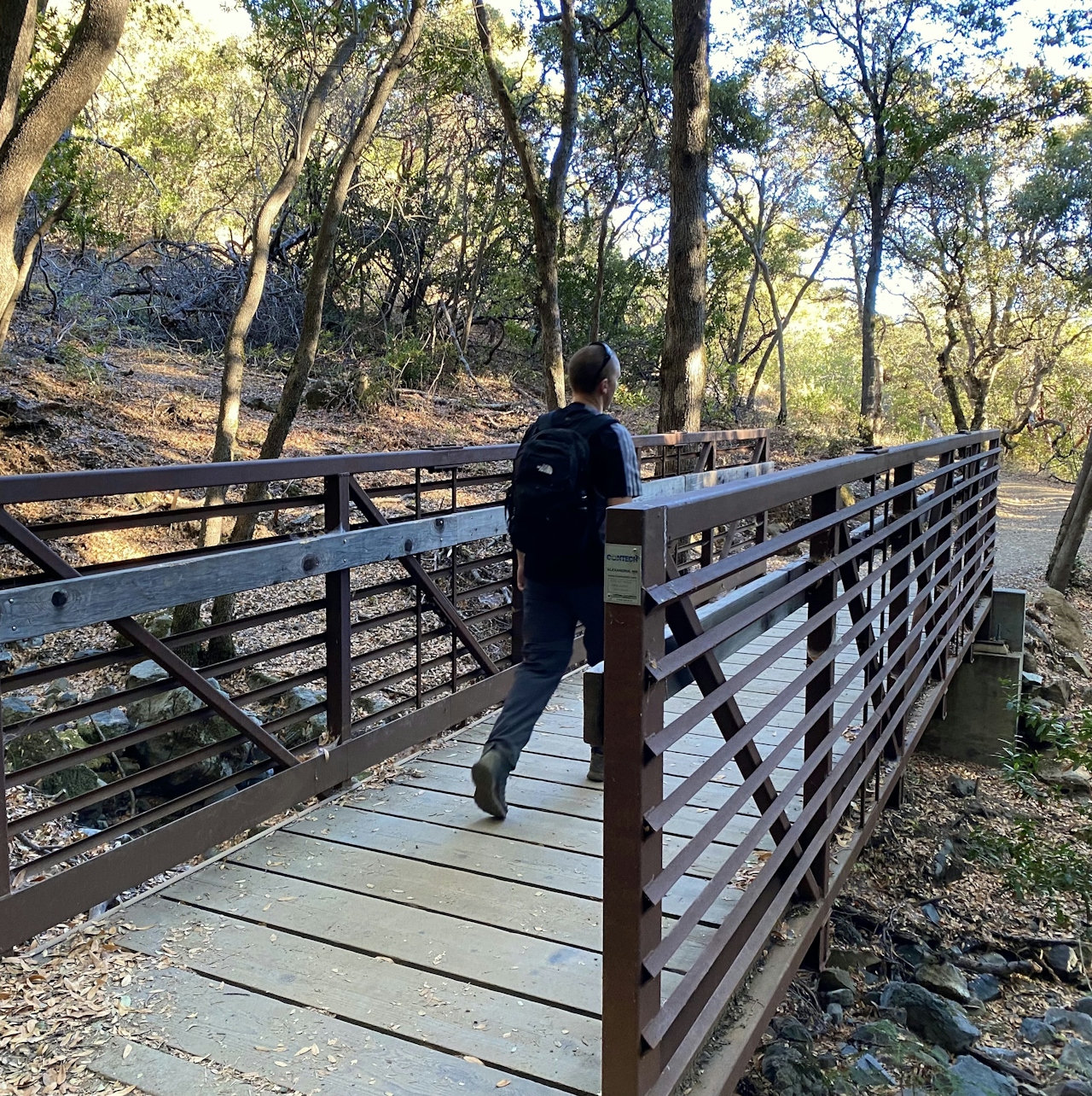 Hiker crossing a bridge on the Bay Area Ridge Trail at Mount Umunhum 