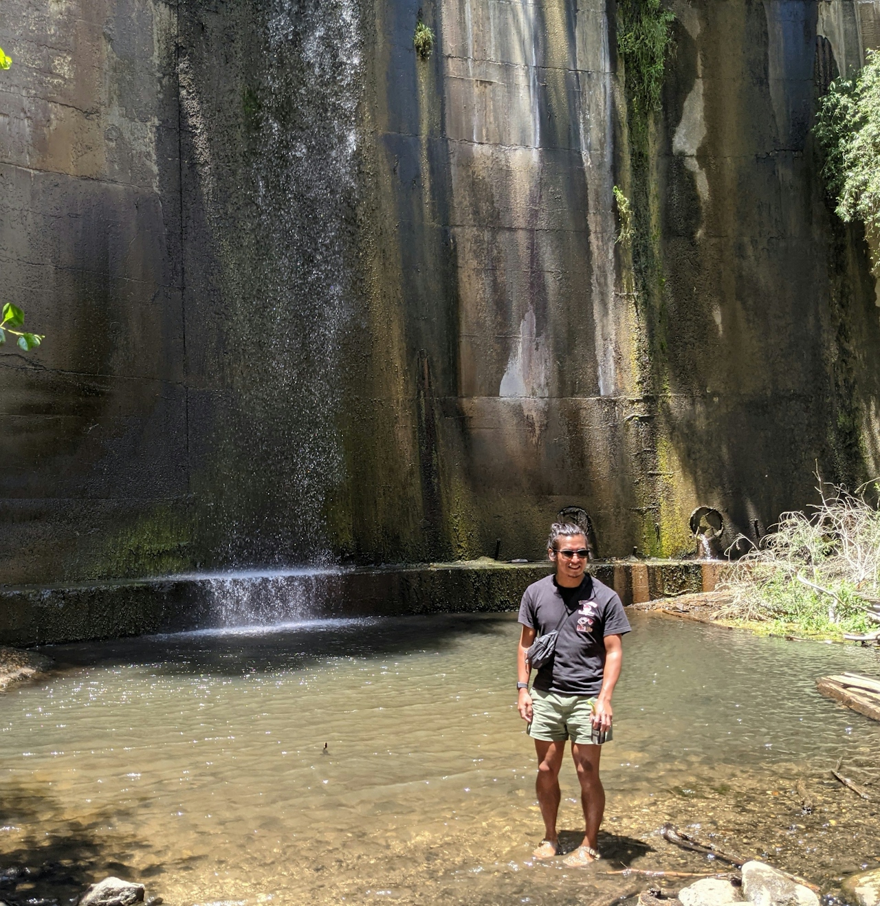 Man standing at the edge of the water at the historic Brown Mountain Dam in Southern California 