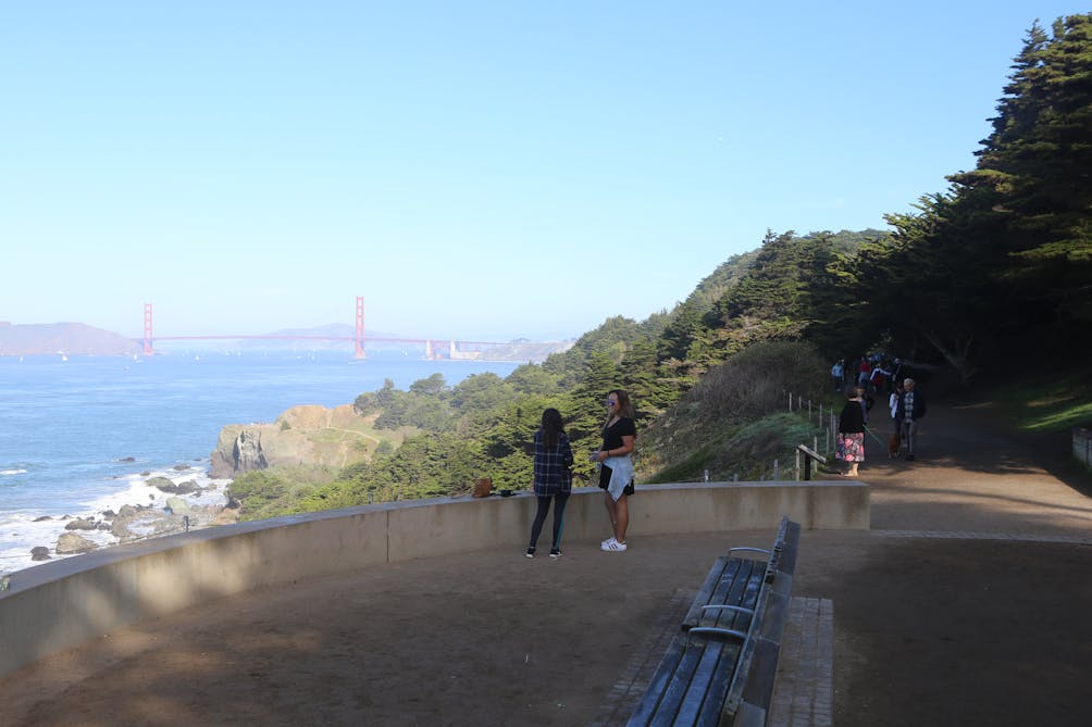 Hikers on the Coastal Trail overlooking the Golden Gate Bridge in San Francisco 