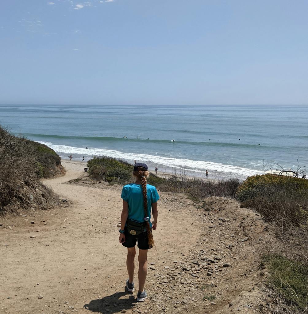 Woman hiking the San Onofre Bluffs Loop Trail overlooking San Onofre State Beach in San Diego County 