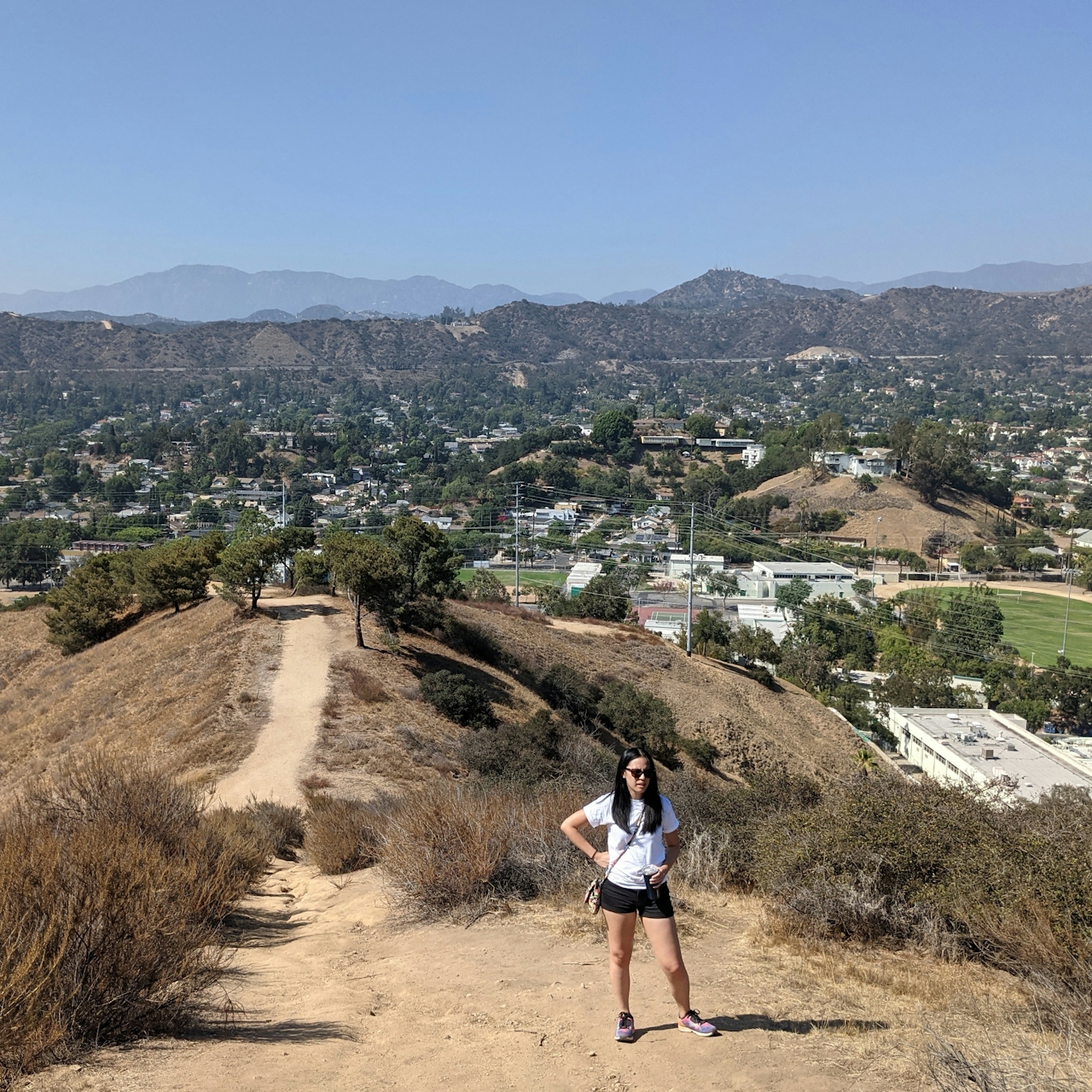 Hiker taking a break on the ascent of the trail at Fiji Hill in Los Angeles 