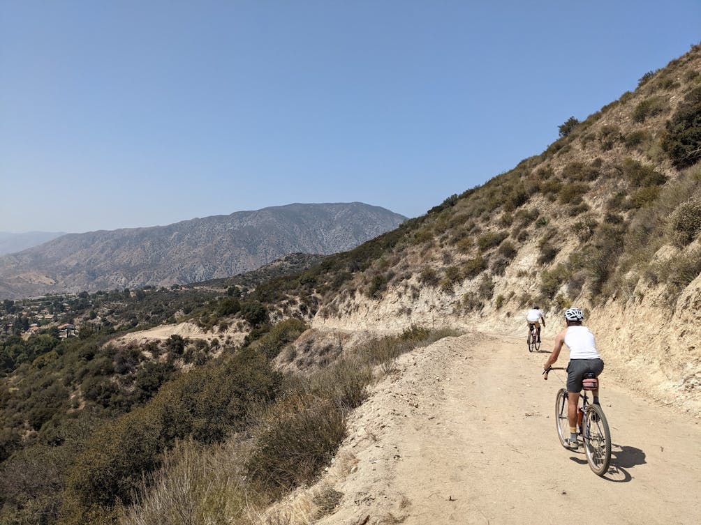 Mountain Bikers on a trail in Haines Canyon Debris Basin in the San Gabriels Southern California 