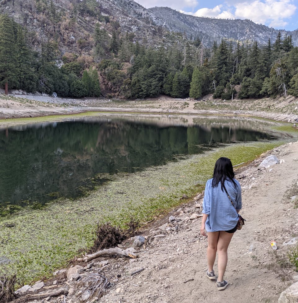 Woman standing at Crystal Lake in the Angeles National Forest Southern California