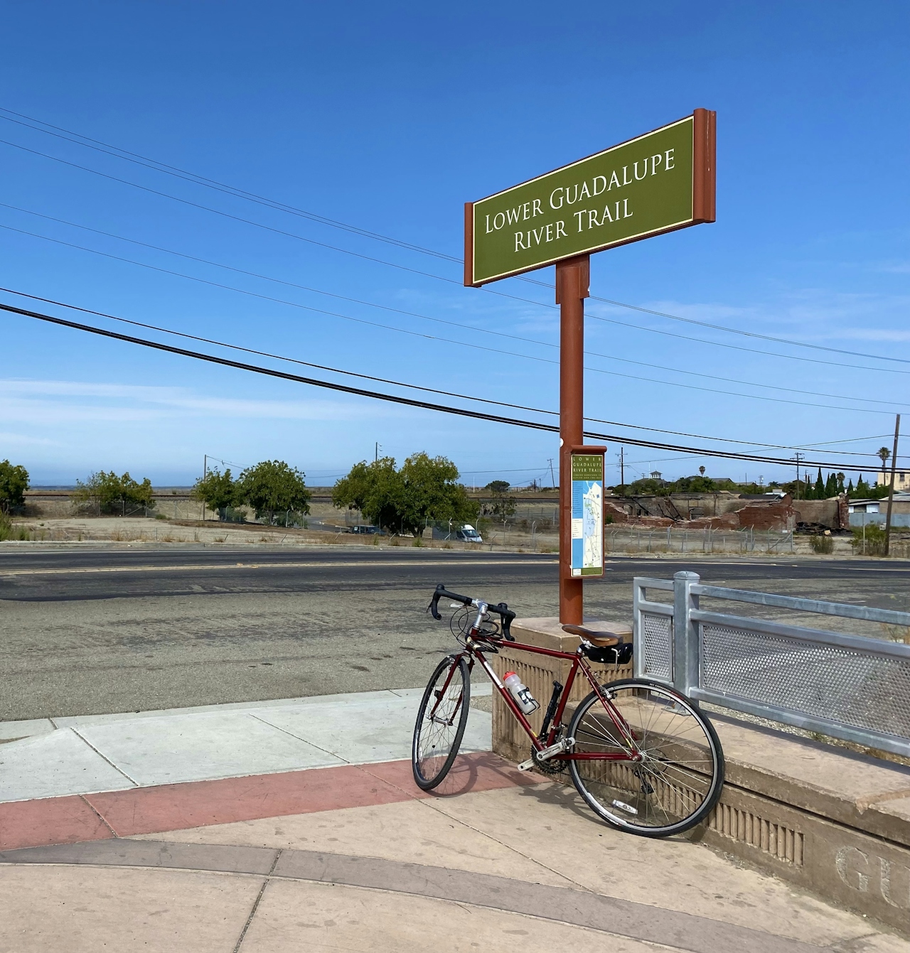 Bike leaned up against the sign for the Guadalupe River Trail in San Jose 