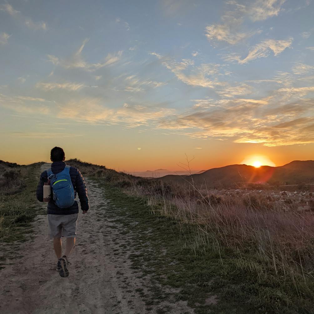 Hiker on a trail at sunset at Big Sky Trail in Simi Valley 