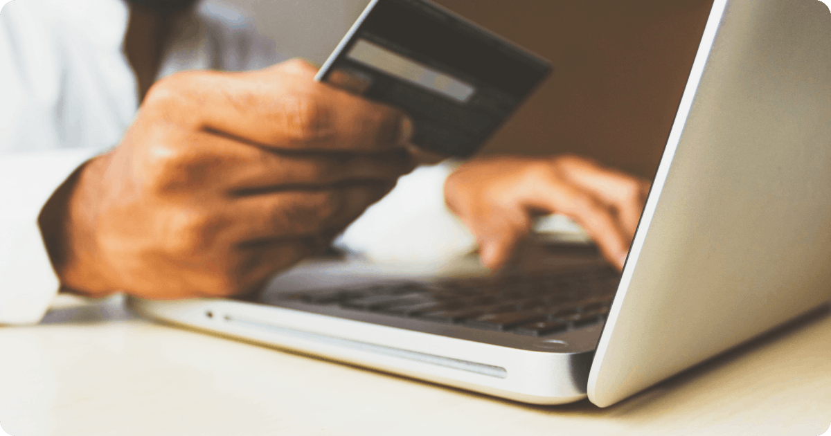 man using card in laptop