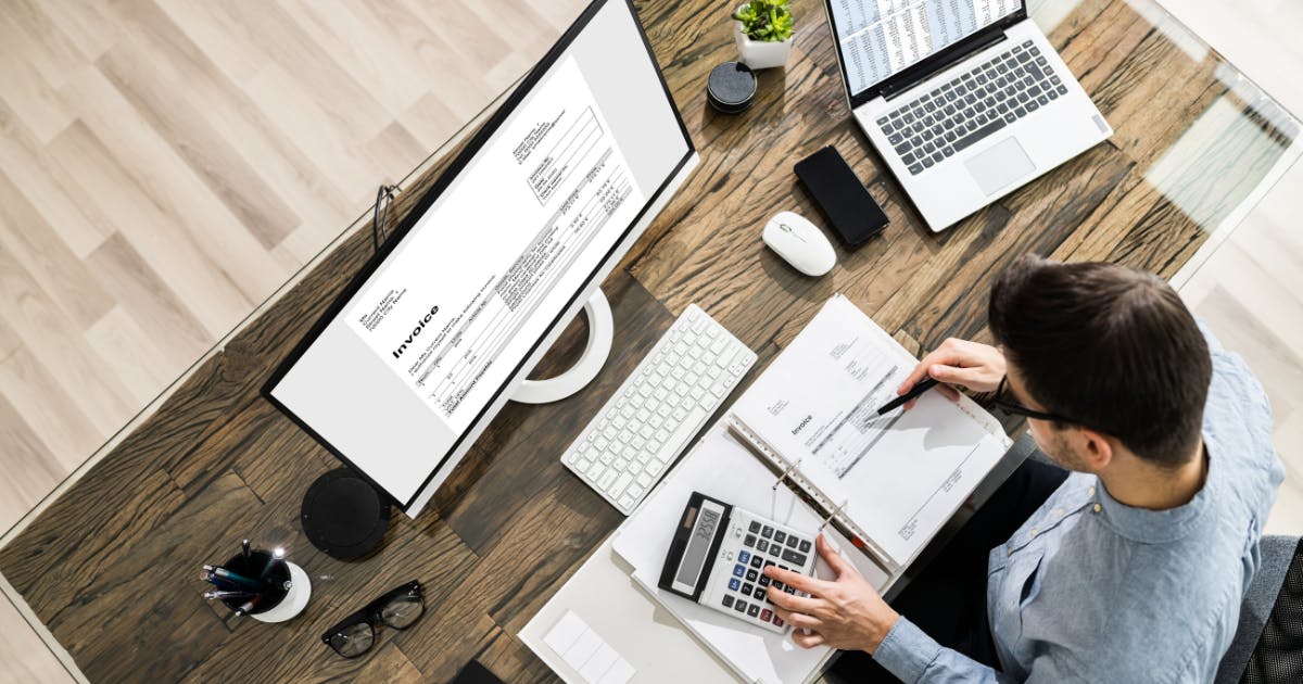 Person reviewing invoices to understand what is accounts payable and manage business expenses effectively.