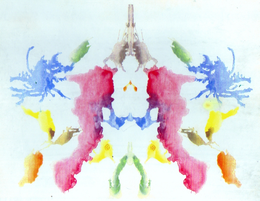 A yellow, pink, green and blue symmetrical inkblot.