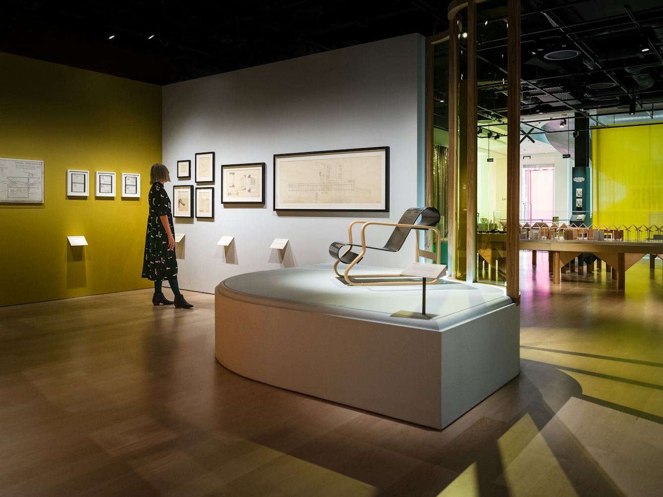 Photograph of curator Emily Sargent looking at the exhibition Living with Buildings at Wellcome Collection.