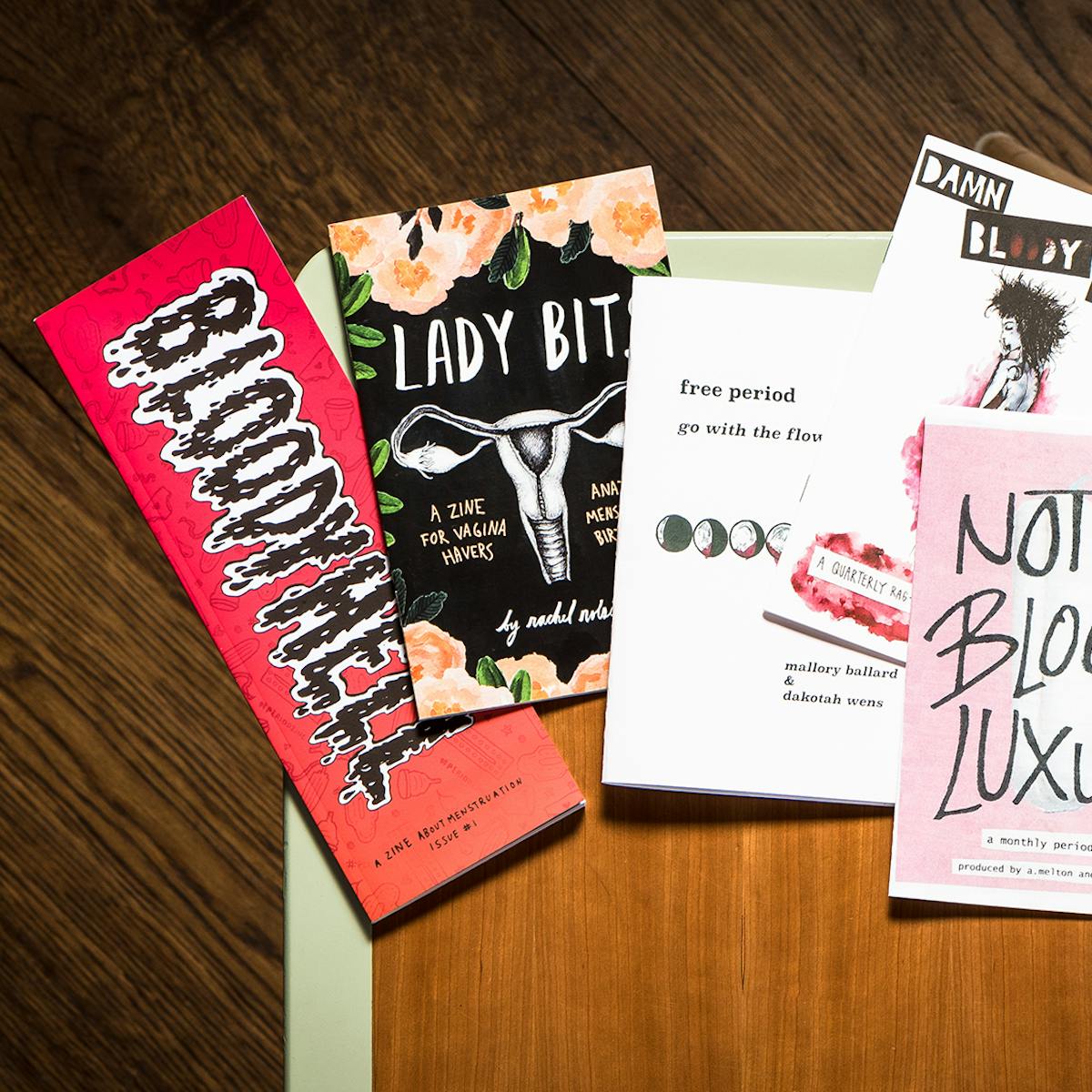 Photograph of multiple period zines on a library desk