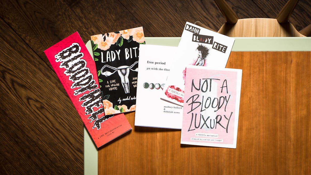 Photograph of multiple period zines on a library desk