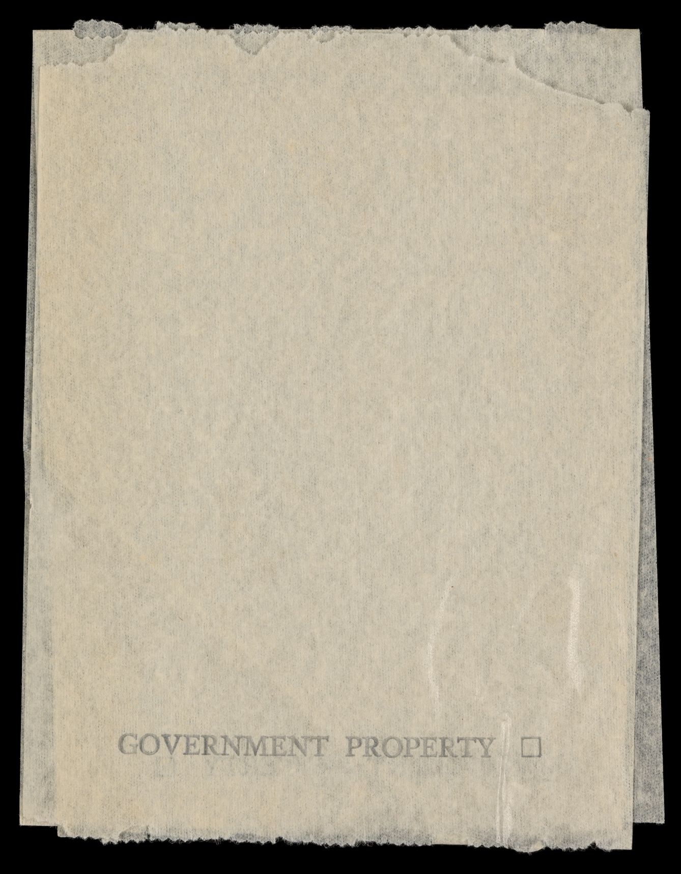 Photograph of a toilet paper sample sheet, bearing the stamp, "Government Property" across the bottom of the sheet.
