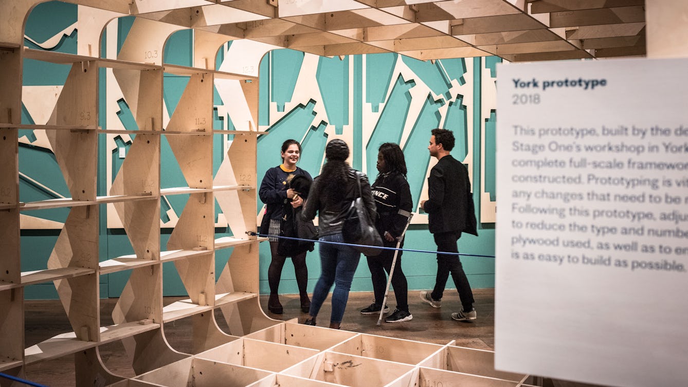 Photograph of a group of people exploring the Global Clinic exhibition at Wellcome Collection.
