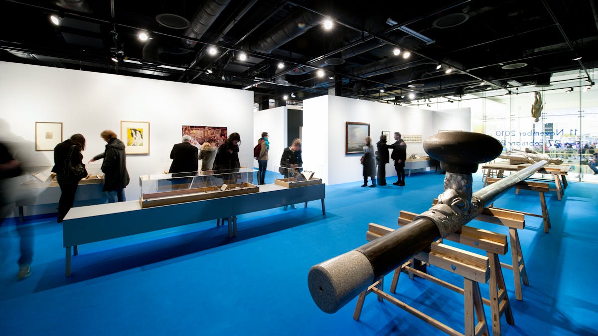 Photograph of visitors in the High Society exhibition at Wellcome Collection.