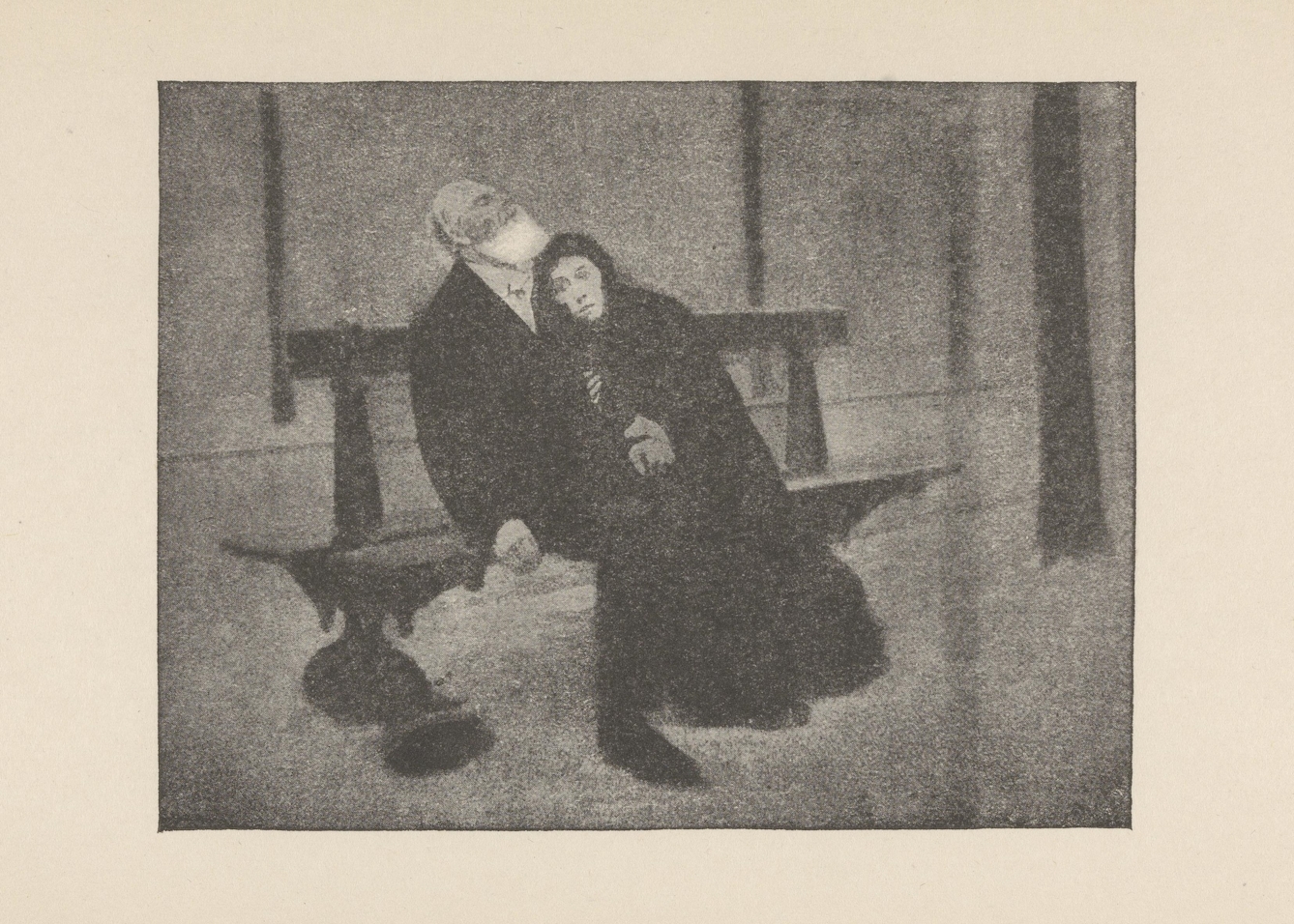 Black and white image of a man and woman sitting on a bench. The woman is leaning into the man.