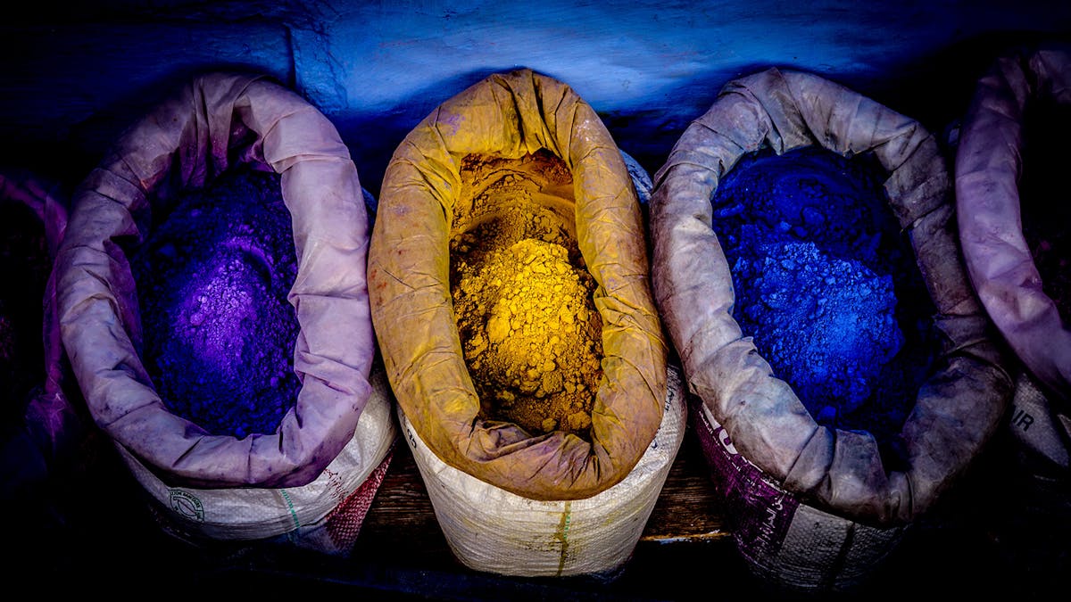Sacks containing brightly coloured yellow and blue powder pigments