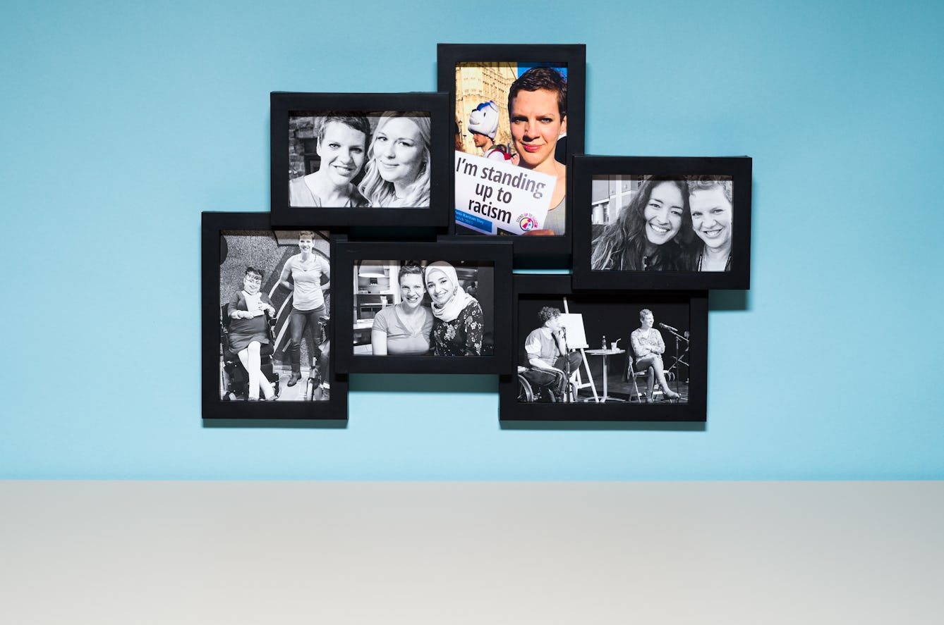 Photograph of a multi-frame photo frame containing six photographs, one in colour and the others in black and white. The frame is hung on a light blue wall above a grey tabletop.