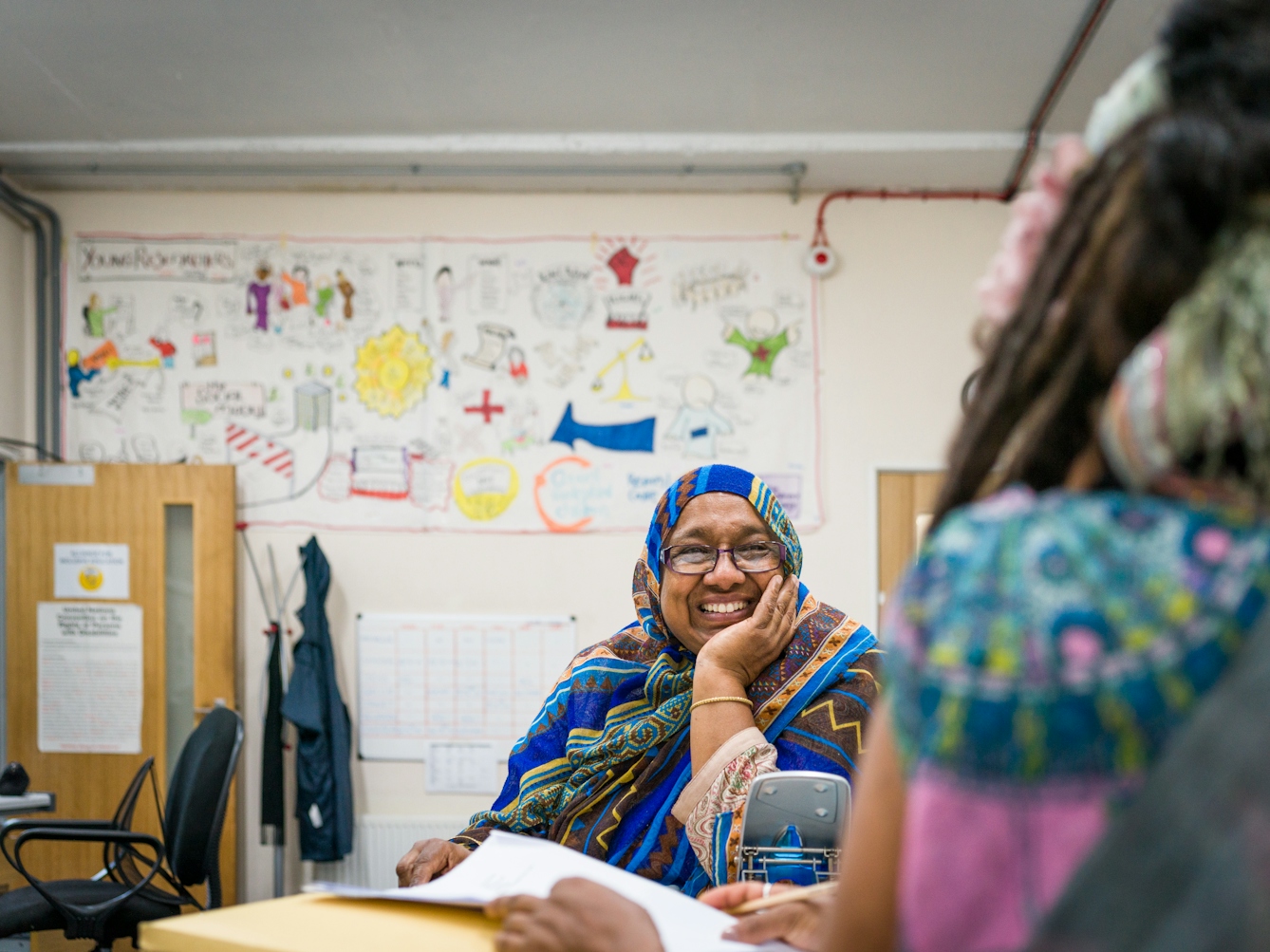 Photograph of Sarifa Patel talking with another Trustee of the charity, ALLFIE.