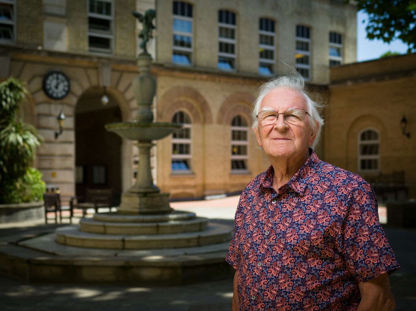 Photographic portrait of a man in the courtyard at UCL Eastman Dental Institute, London.