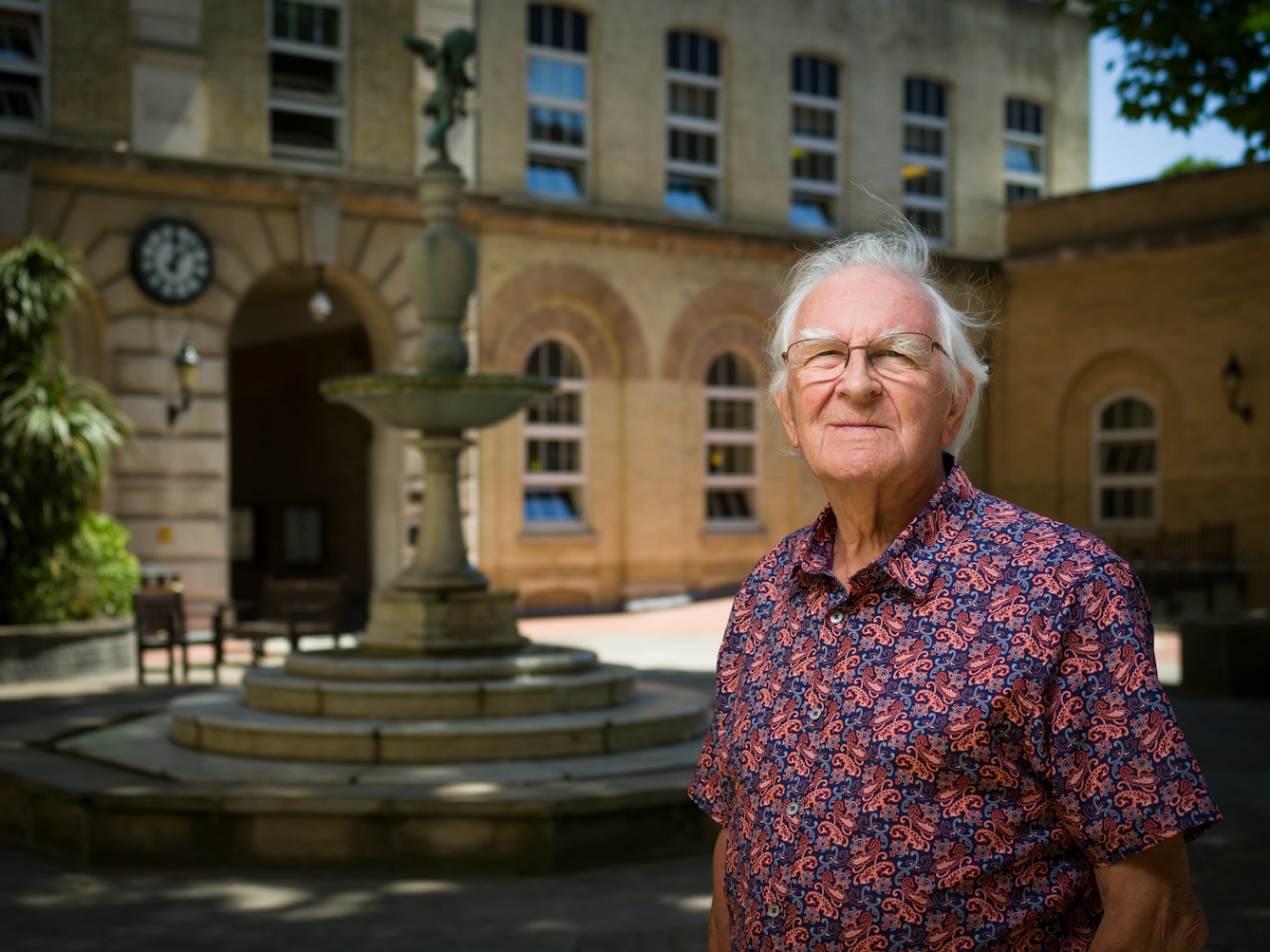 Photographic portrait of a man in the courtyard at UCL Eastman Dental Institute, London. 