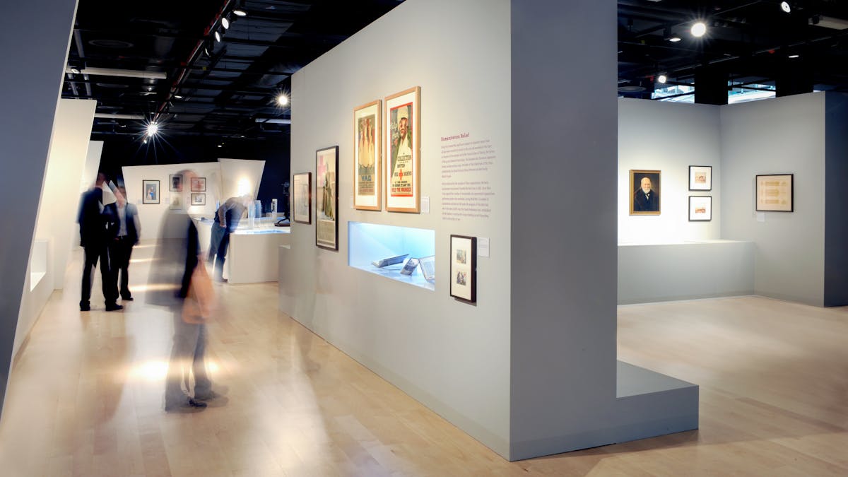 Photograph of visitors exploring the exhibition, War and Medicine at Wellcome Collection.
