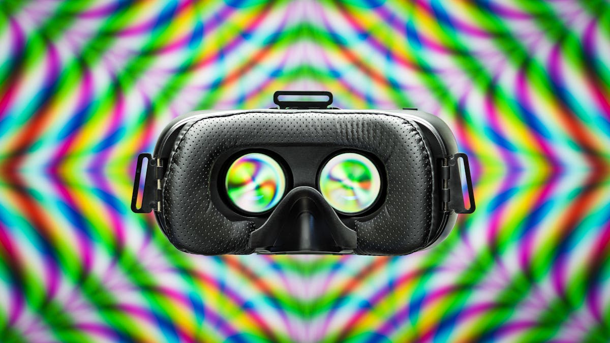 Photograph of a VR headset on a colourful patterned background.