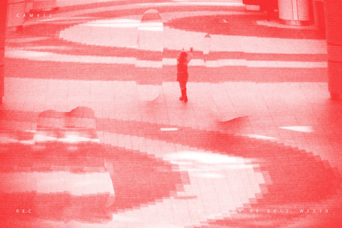 Pixellated photograph from a shopping mall security camera, where all adults have been crudely 'Photoshopped' out of the image, leaving one remaining child. The image has a red/pink tone applied to it.