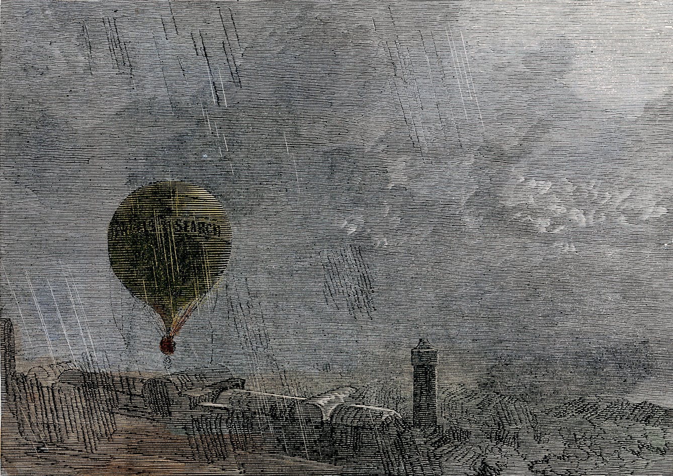 Coloured wood engraving which shows a hot-air balloon leaving the ground in driving rain. A lighthouse can be seen in the distance.