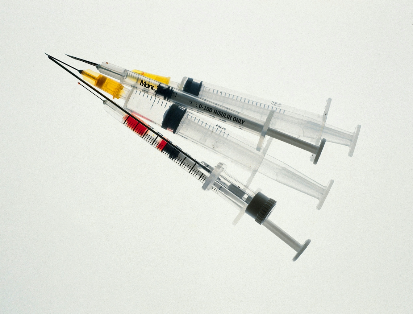 Modern syringes made of plastic with measure lines. One is labelled "insulin only".
