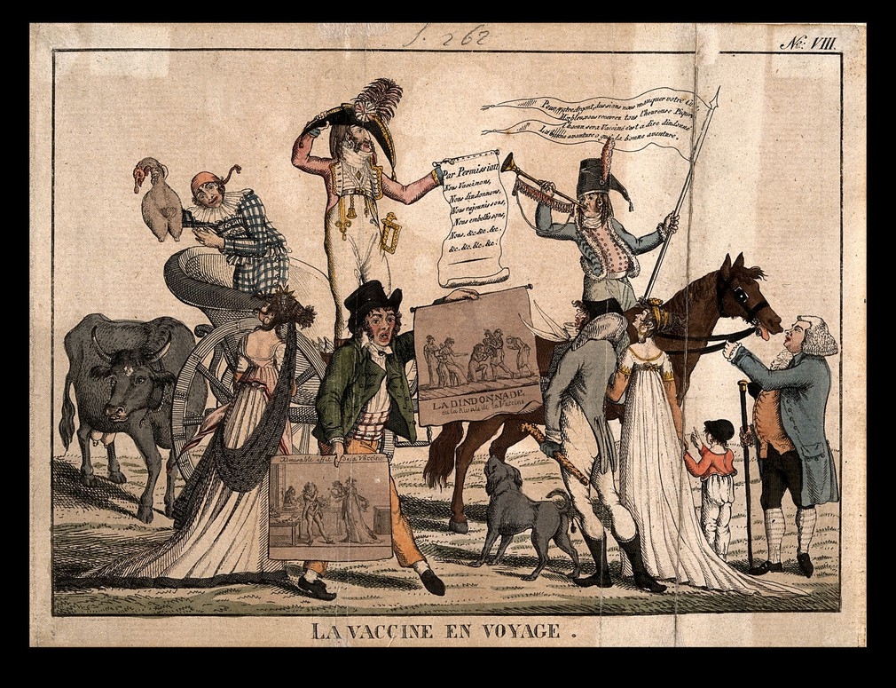The image shows a procession of people protesting the introduction of vaccines in 19th century France. One man rides a horse and plays a trumpet. One woman rides a chariot. They carry banners and flags about the vaccines.