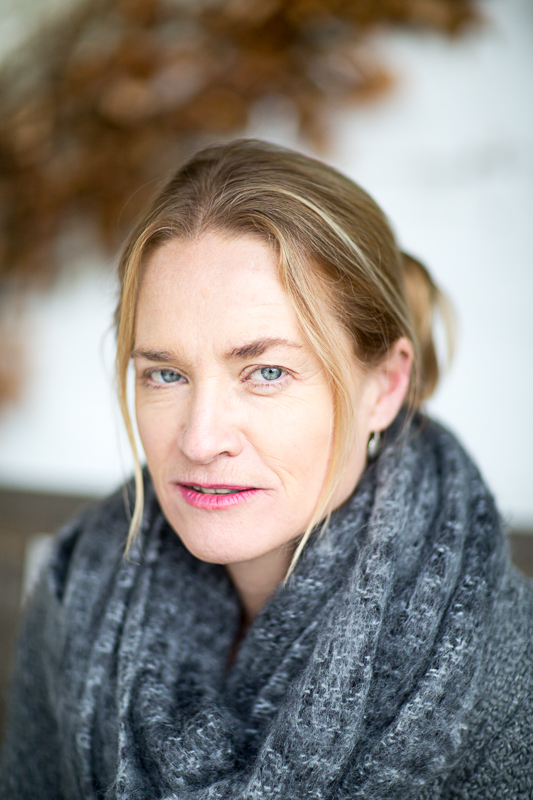 Colour head and shoulders photograph of writer Lizzie Enfield