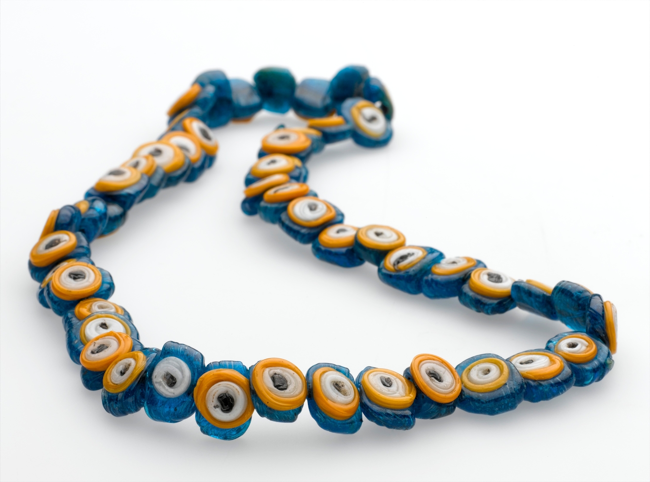 Necklace with flat glass beads, coloured bright blue, yellow and white .
