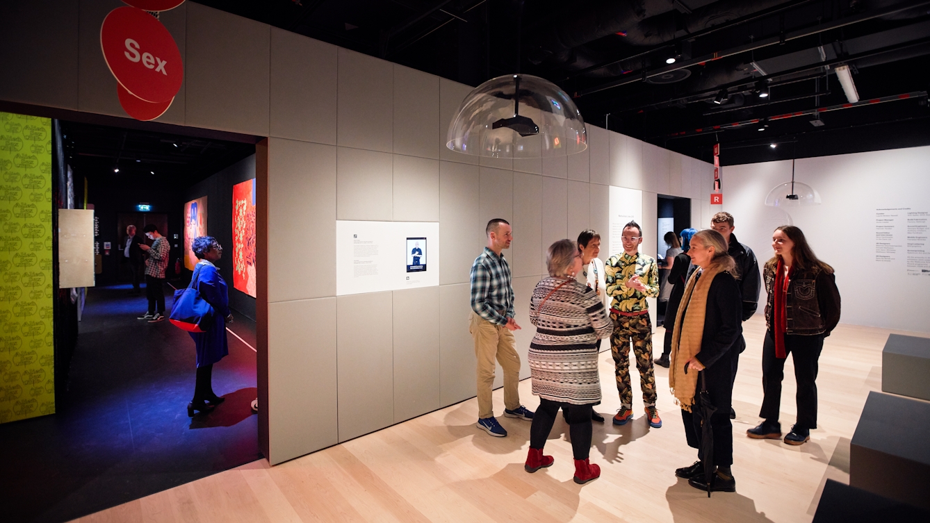 Photograph of people gathered in an exhibition.