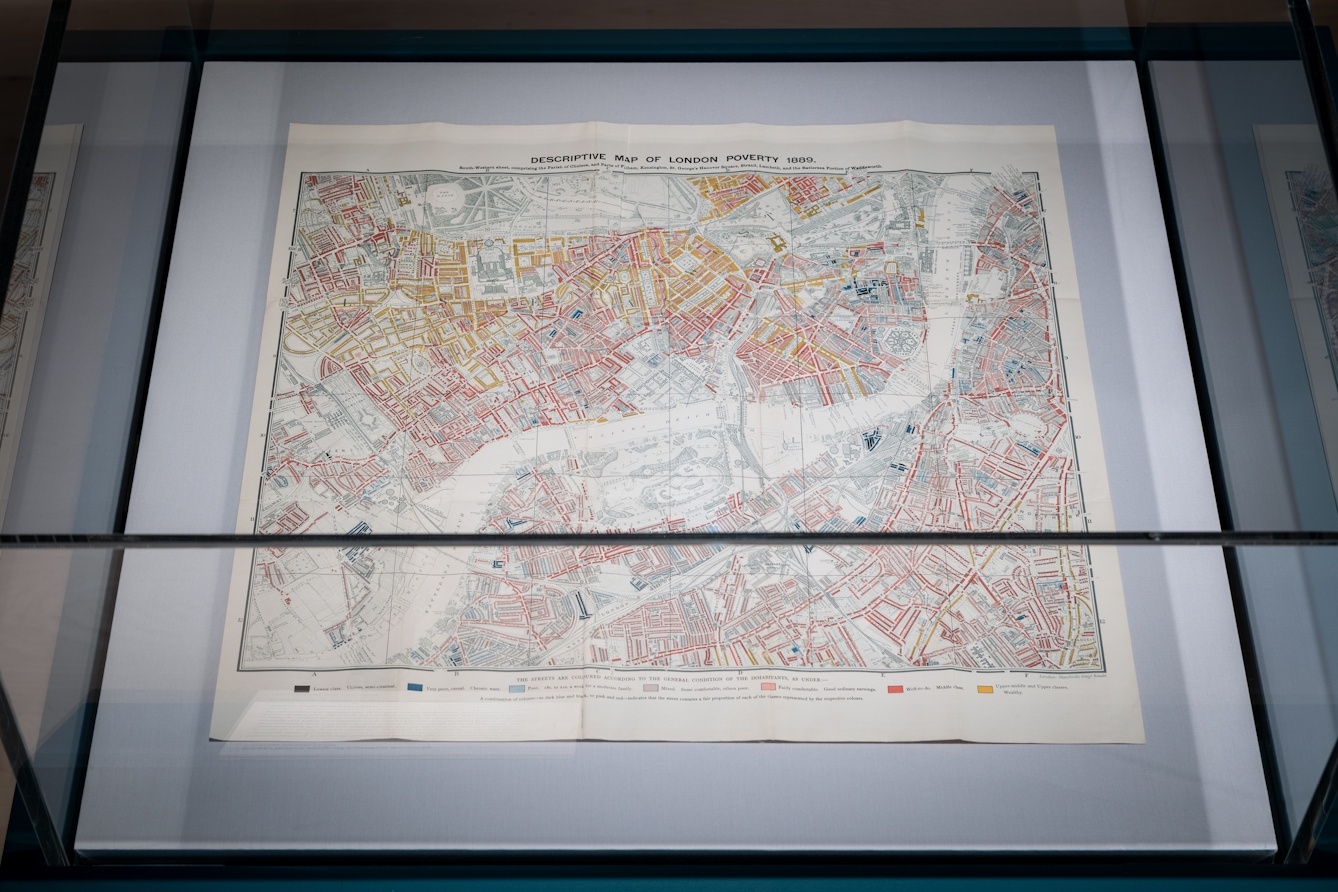 Photograph of an exhibition display case showing a Charles Booth map of poverty in London in 1889, as part of the exhibition living with Buildings at Wellcome Collection.