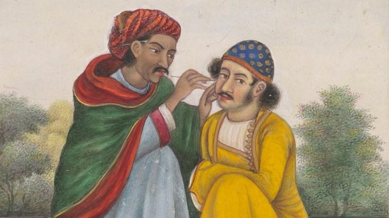A man painting another mans face with makeup