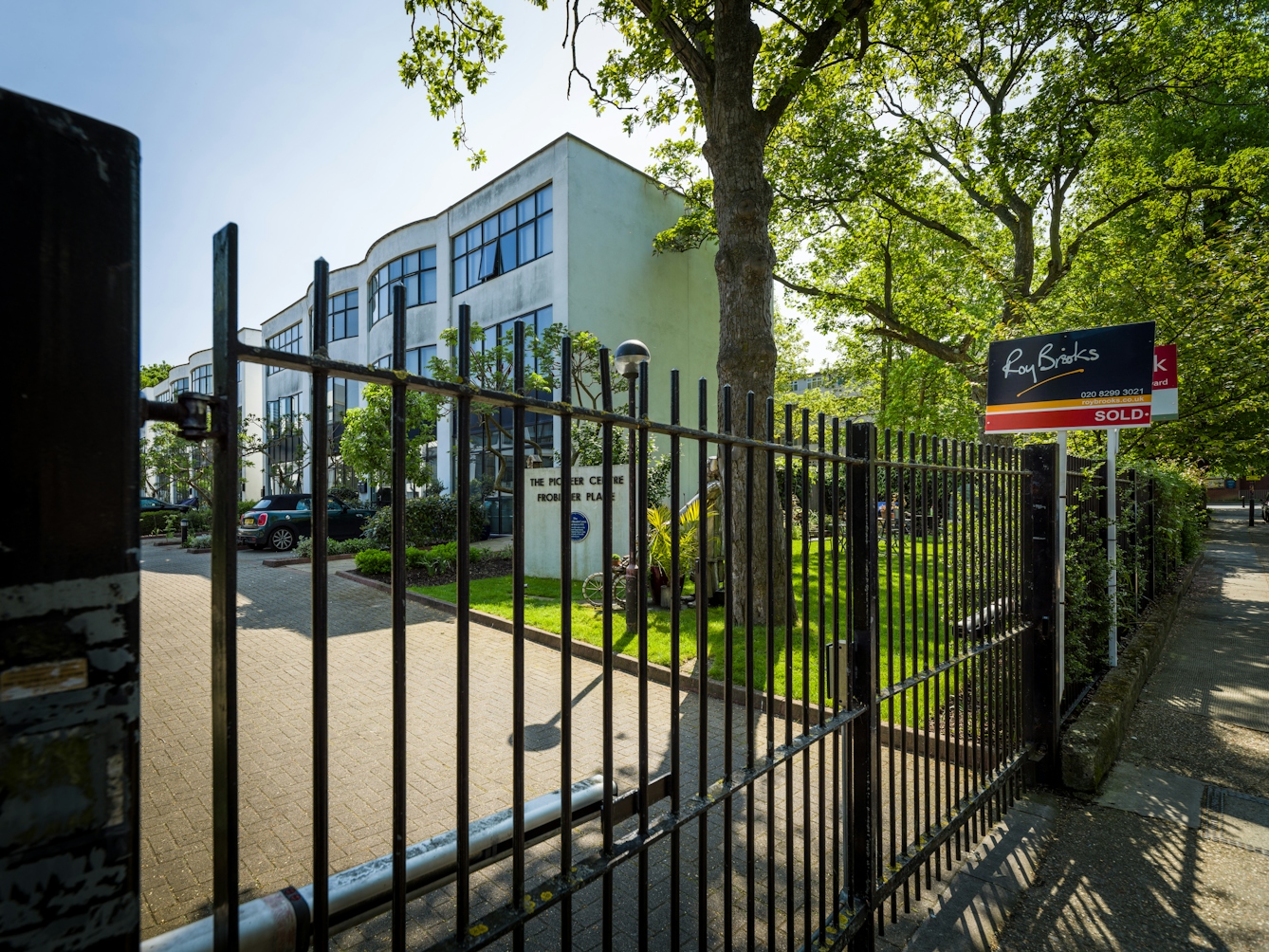 Photograph of the entrance to the The Pioneer Centre in Peckham showing the closed gates and for sale signs.