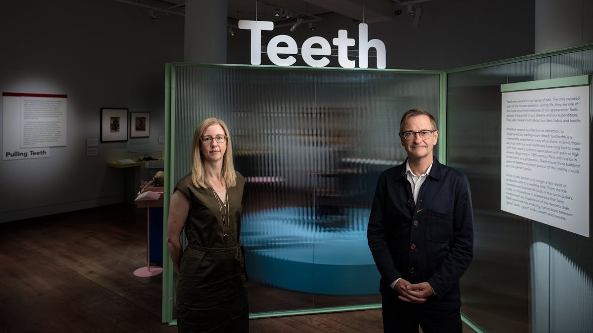 Emily Scott-Dearing and James Peto stand at the entrance to the Teeth exhibition
