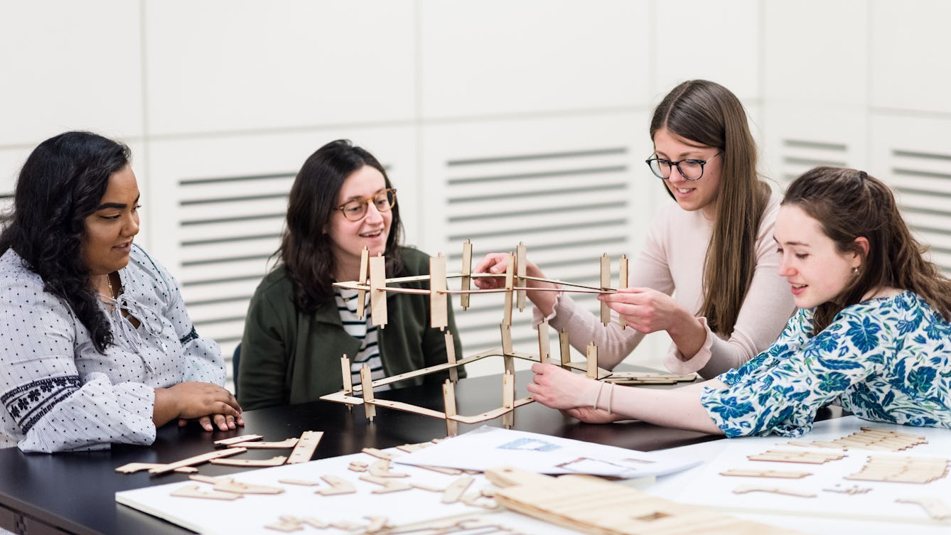 Photograph of four young women engaged in a practical workshop event in the Forum at Wellcome Collection.