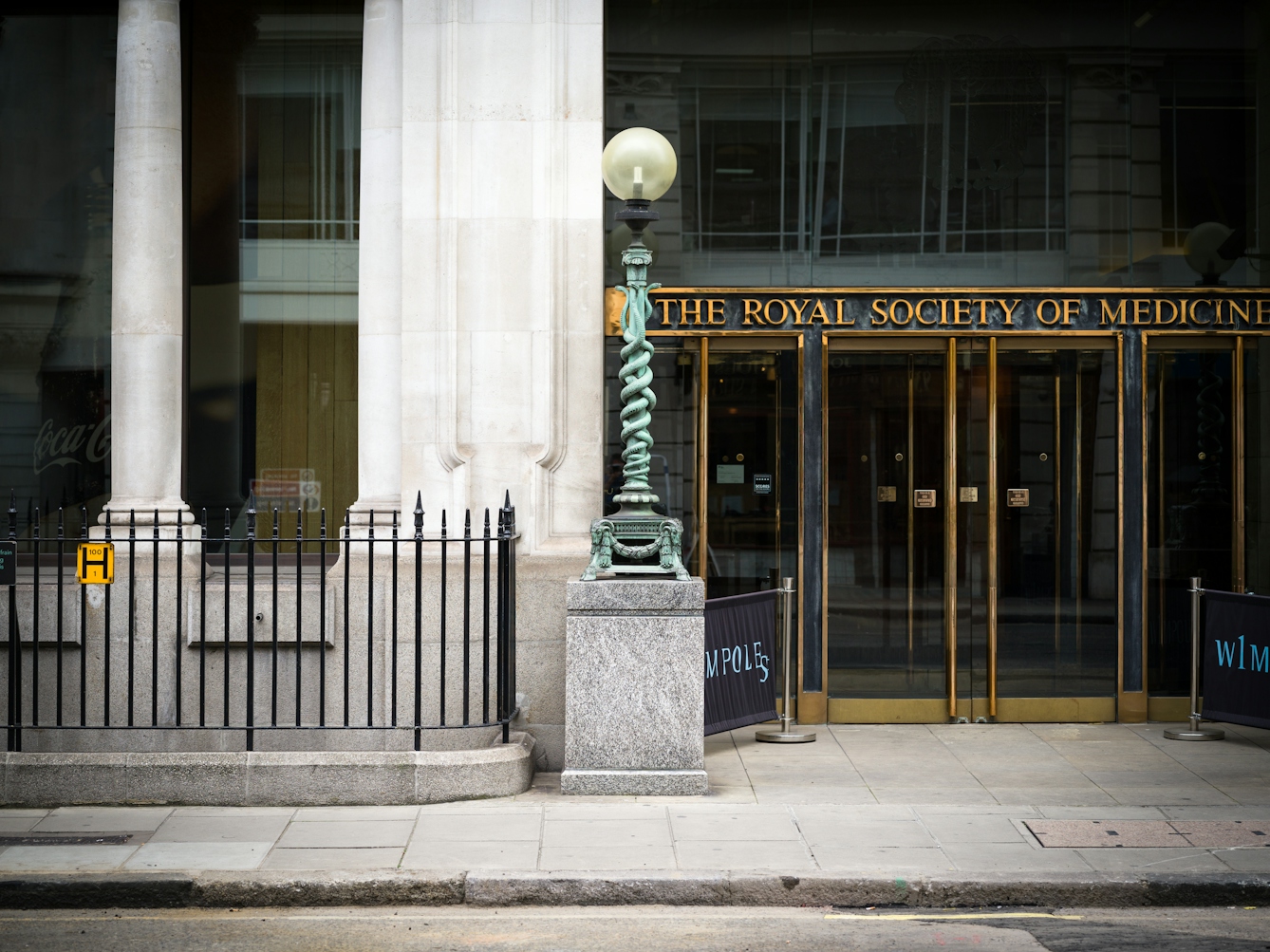 Lamp outside the Royal Society of Medicine, London featuring two snakes entwined.