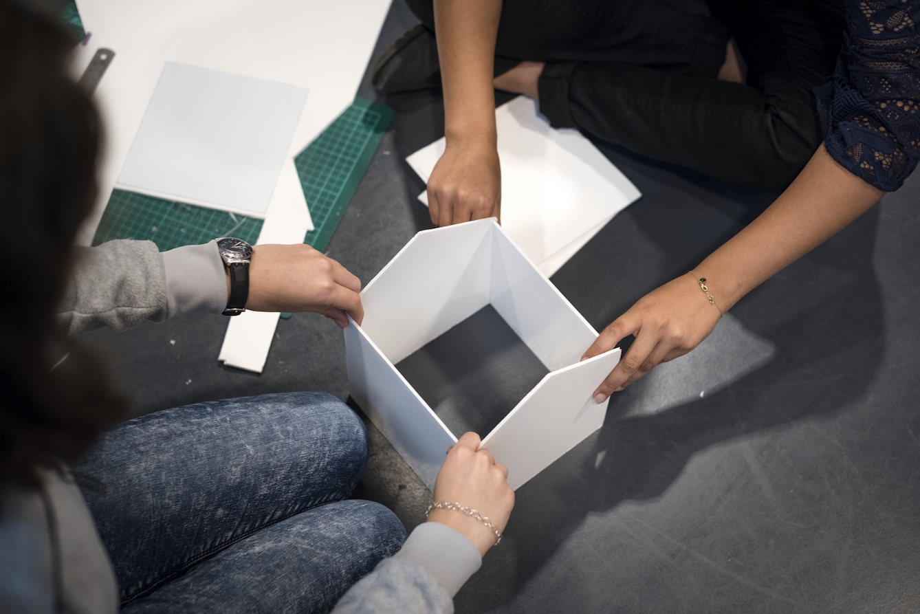 Two people creating a prototype together with card