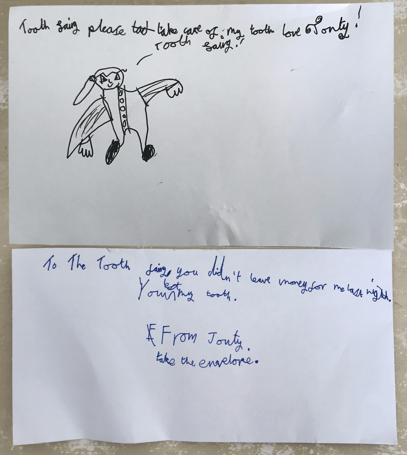 Letter written in black ink on the front of a white piece of paper and blue ink on the reverse. Has an illustration of a woman with what could be wings, with her hair in a pony tail and buttons down her front. Letter front reads: Tooth Fairy, please take care of my tooth, love Jonty! Letter reverse reads: To the Tooth Fairy. you didn't leave money for me last night. You kept my tooth. From Jonty. Take the envelope.
