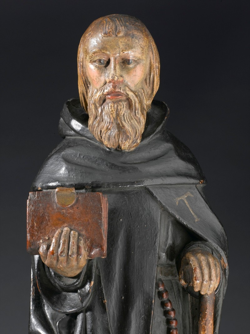 Photo of statue of bearded man holding a book