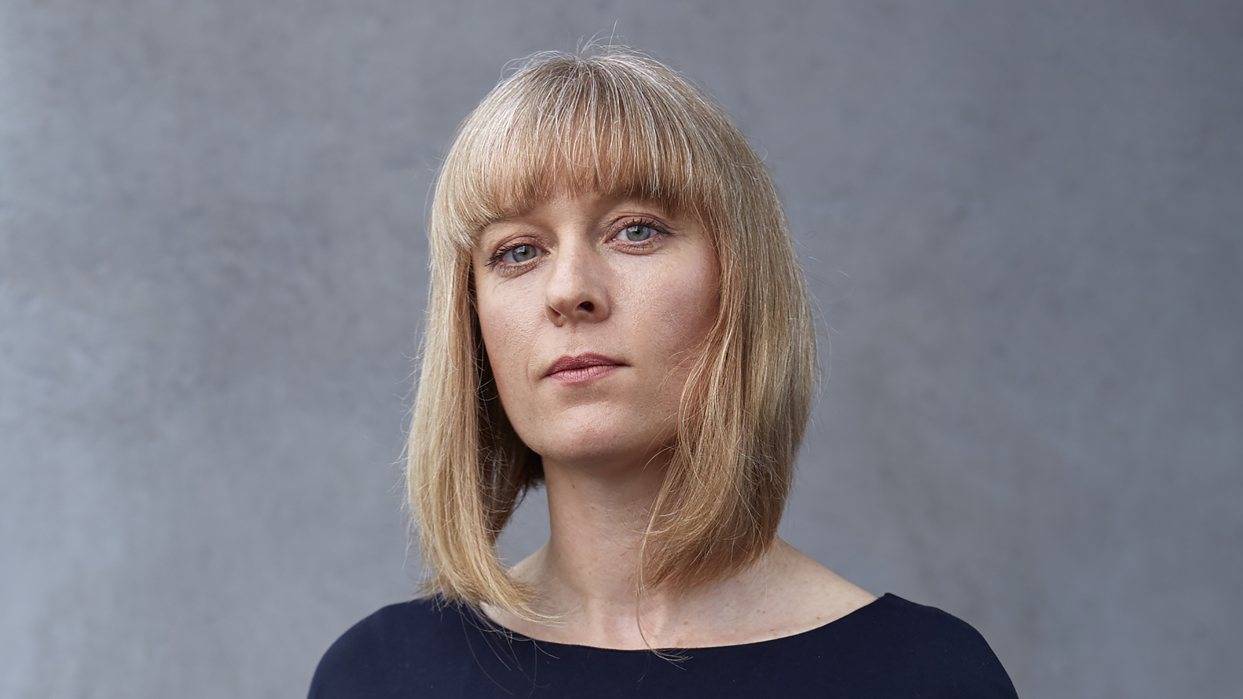 Sophie Woolley's headshot. Her hair is in a long bob. 