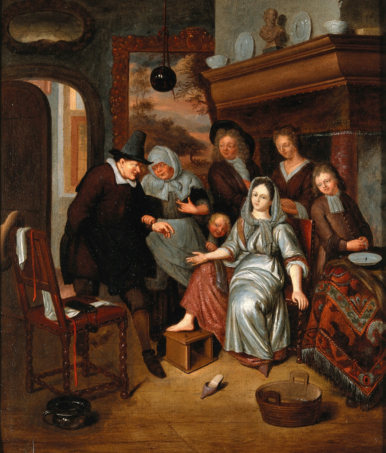 A woman surrounded by five people with her bare ankle raised onto a box in readiness for a surgeon wearing black to bleed her. The surgeon is wearing black and has tools of his trade on a chair beside him. 