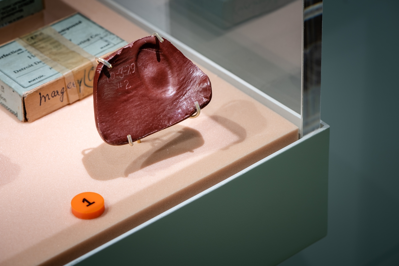 Photograph of Margery Crandon's wax fingerprint impression in a display case, as part of the Smoke and Mirrors exhibition at Wellcome Collection.