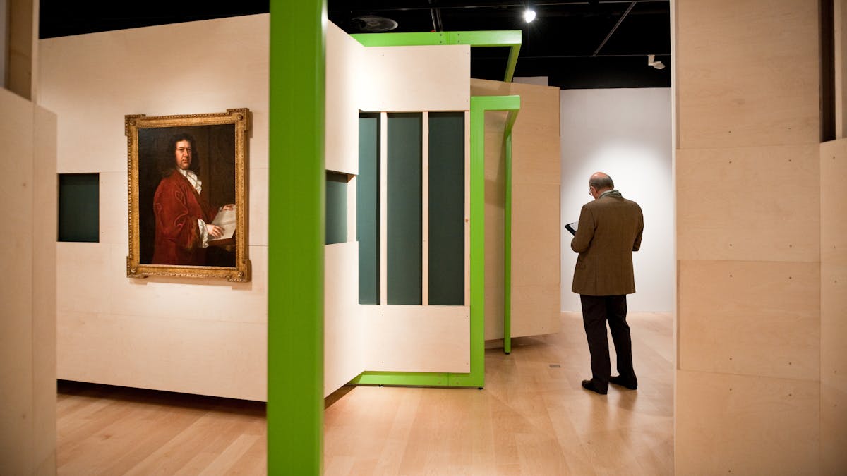 Photograph of a visitor exploring the Identity exhibition at Wellcome Collection.