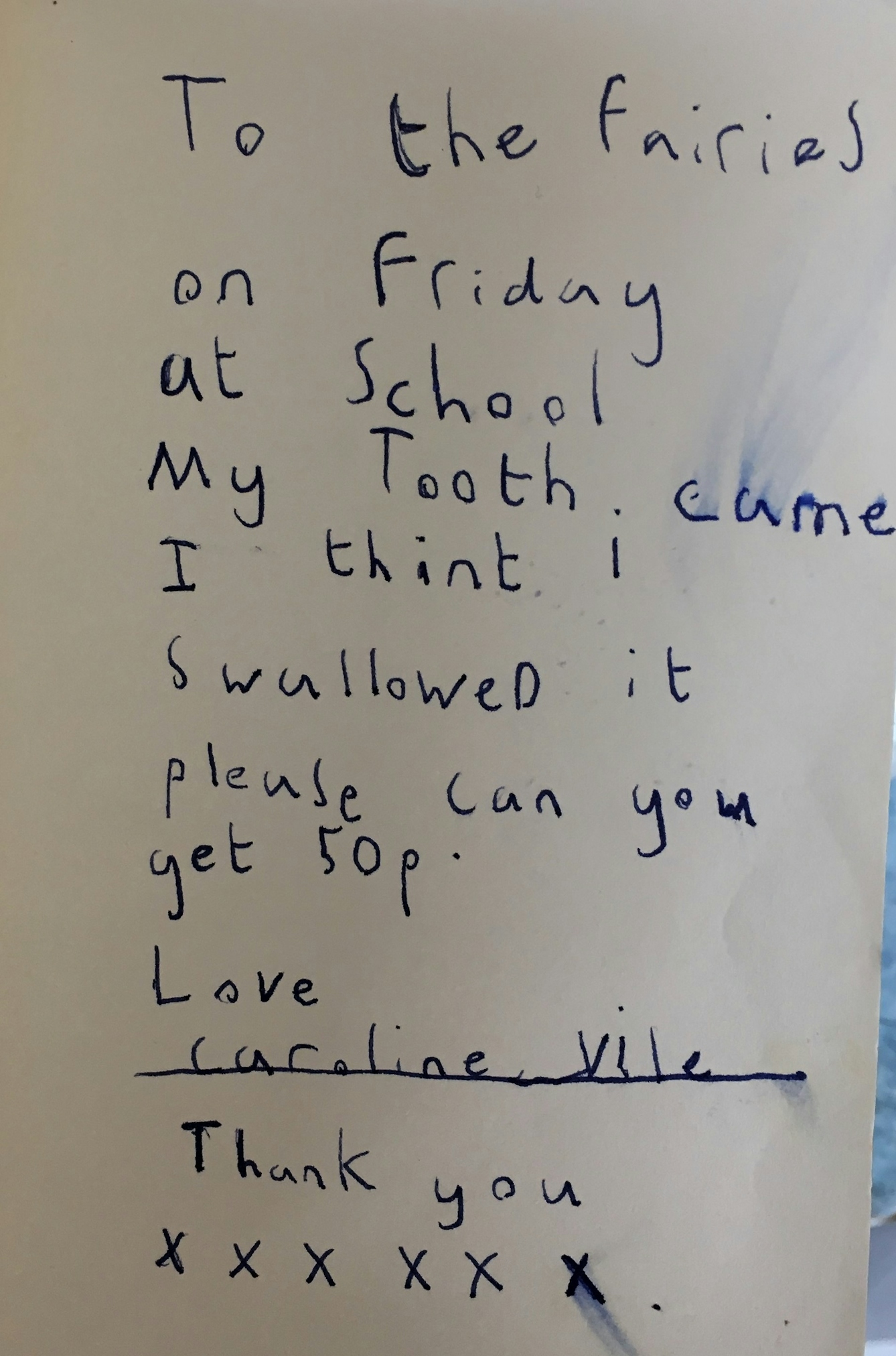 Letter written in blue ink on plain white paper. Reads: To the fairies. On Friday at school my tooth came. I think I swallowed it. Please can you get 50p. Love, Caroline Vile. Thank you. XXXXXX